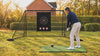 Golfer hitting a driver into the 7 ft practice net in a garden